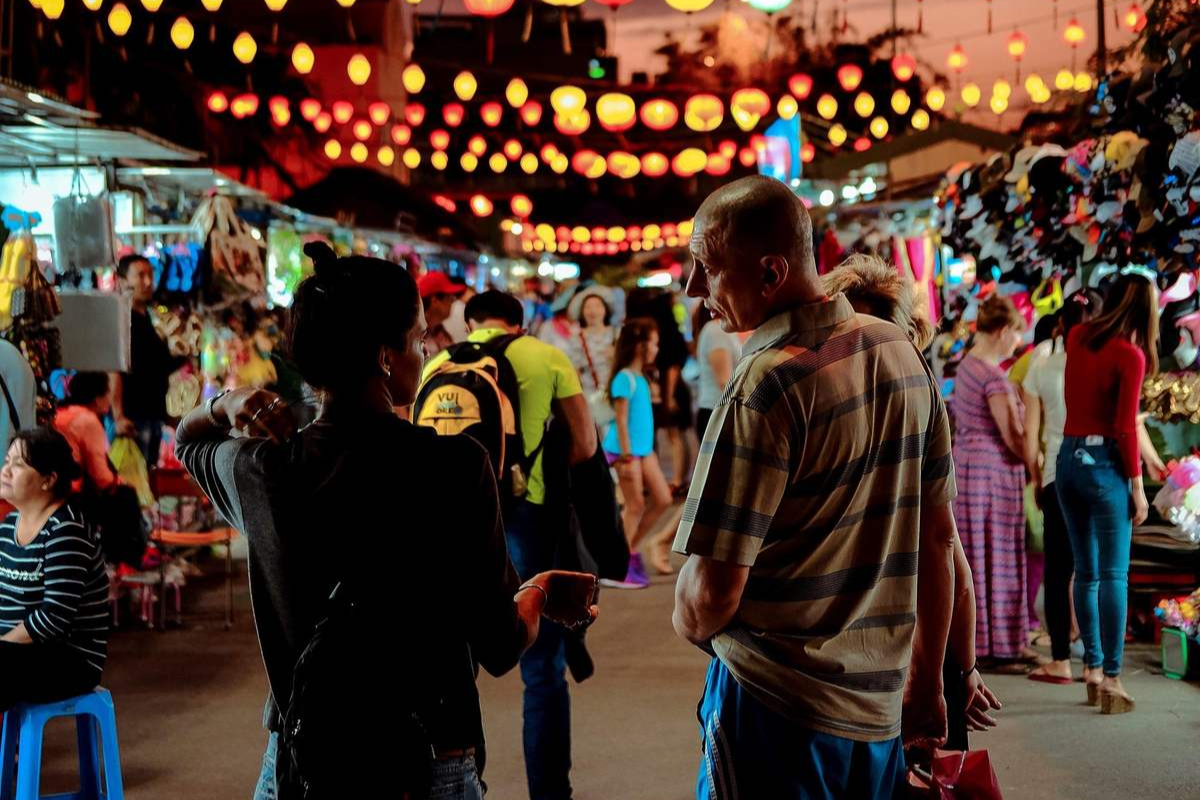 Colorful lanterns and neon signs lighting up Nha Trang Night Market creating a festive vibe
